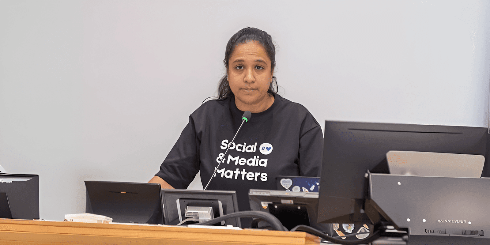 Arnika Singh, Director at Social & Media Matters, speaks at a conference on digital safety, focusing on sextortion awareness.