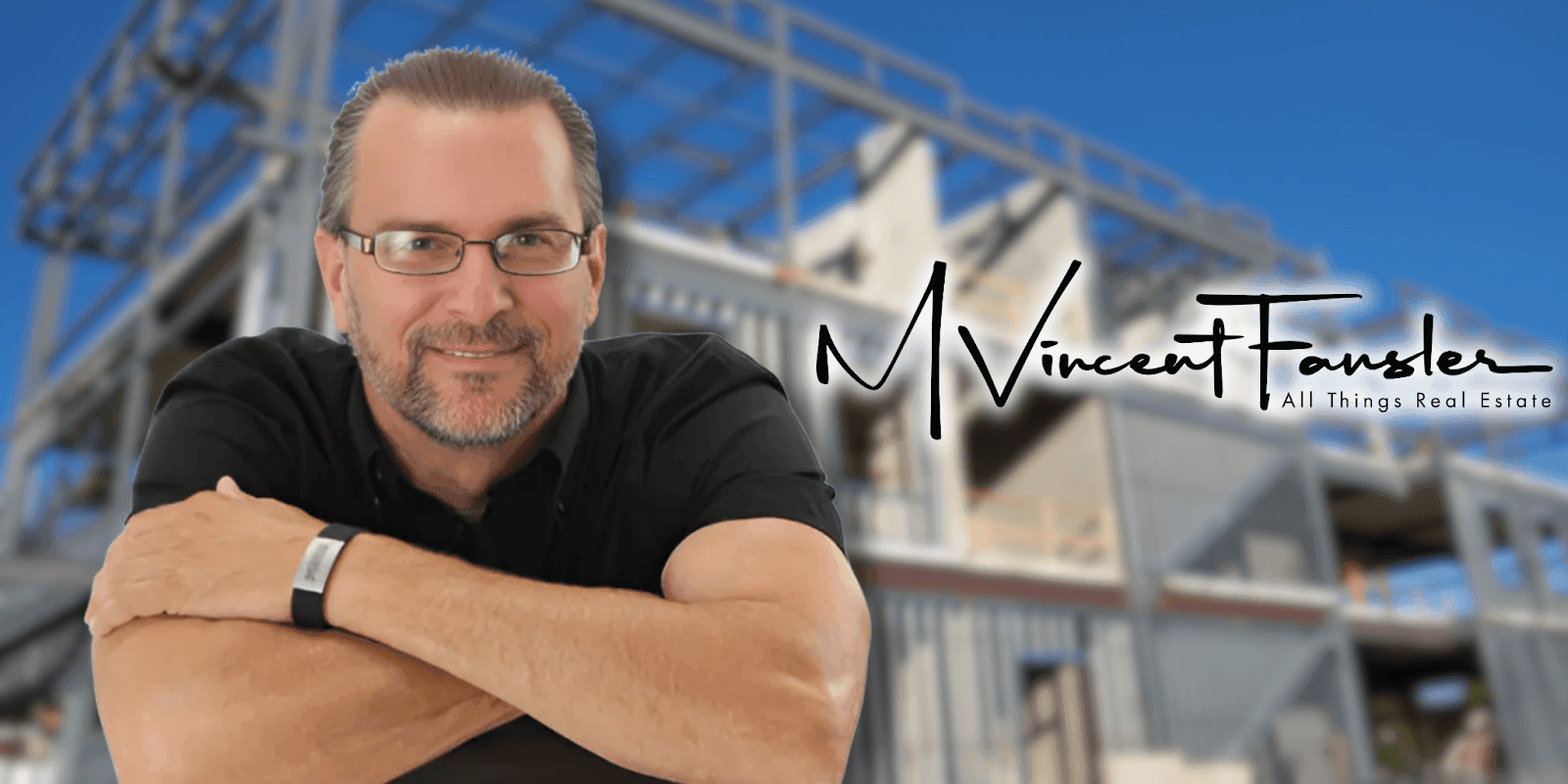 Smiling man in glasses poses in front of a modern building under construction with "M Vincent Fansler" logo.