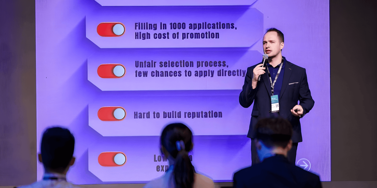 Speaker presenting at an event, highlighting challenges in public speaking, with SpeakUp’s AI platform offering solutions for the industry.