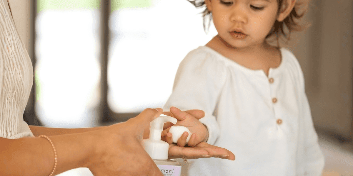 "Evangeline Stacy, founder of Komoni, demonstrating the use of handcrafted wellness products designed to restore and replenish daily well-being."