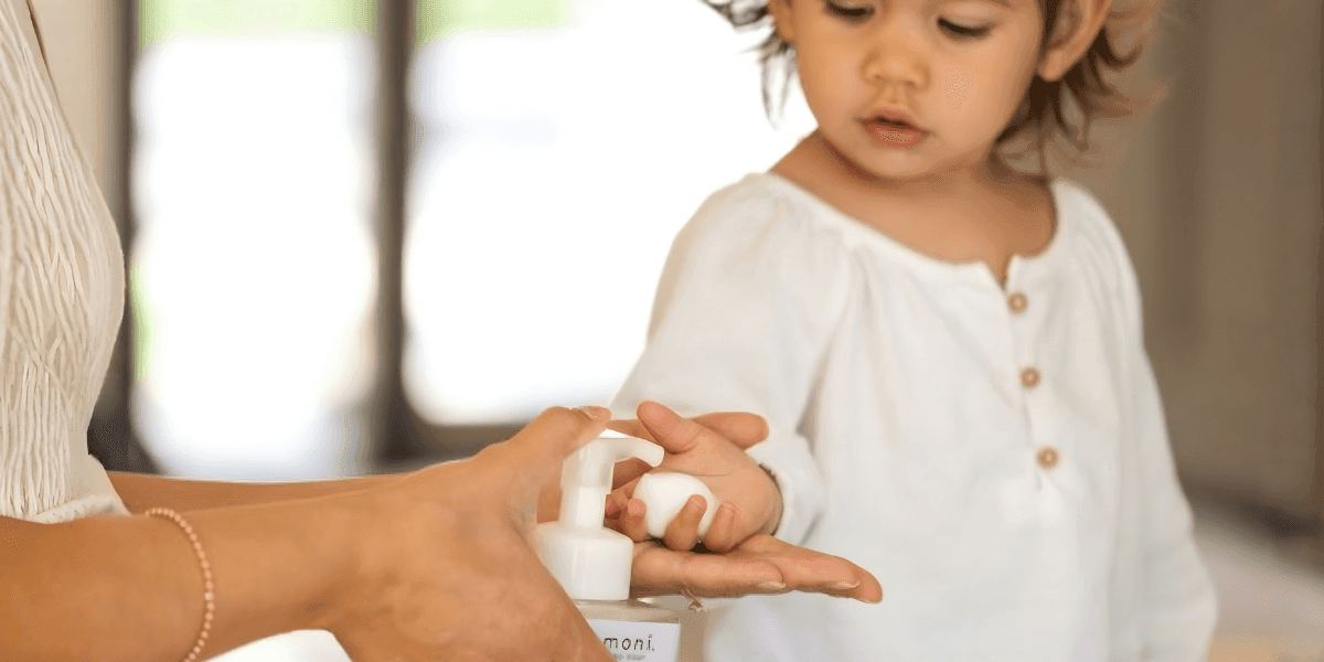 "Evangeline Stacy, founder of Komoni, demonstrating the use of handcrafted wellness products designed to restore and replenish daily well-being."