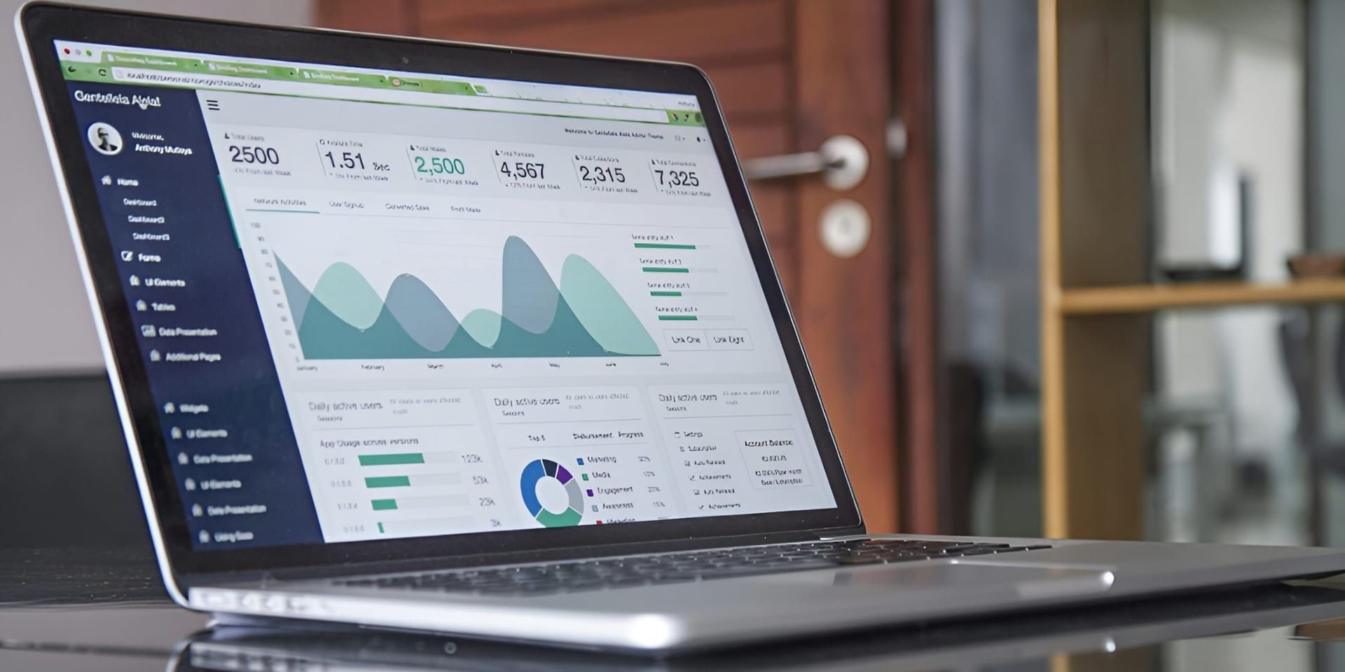 Laptop displaying data analytics with various charts, graphs, and user statistics on the screen.