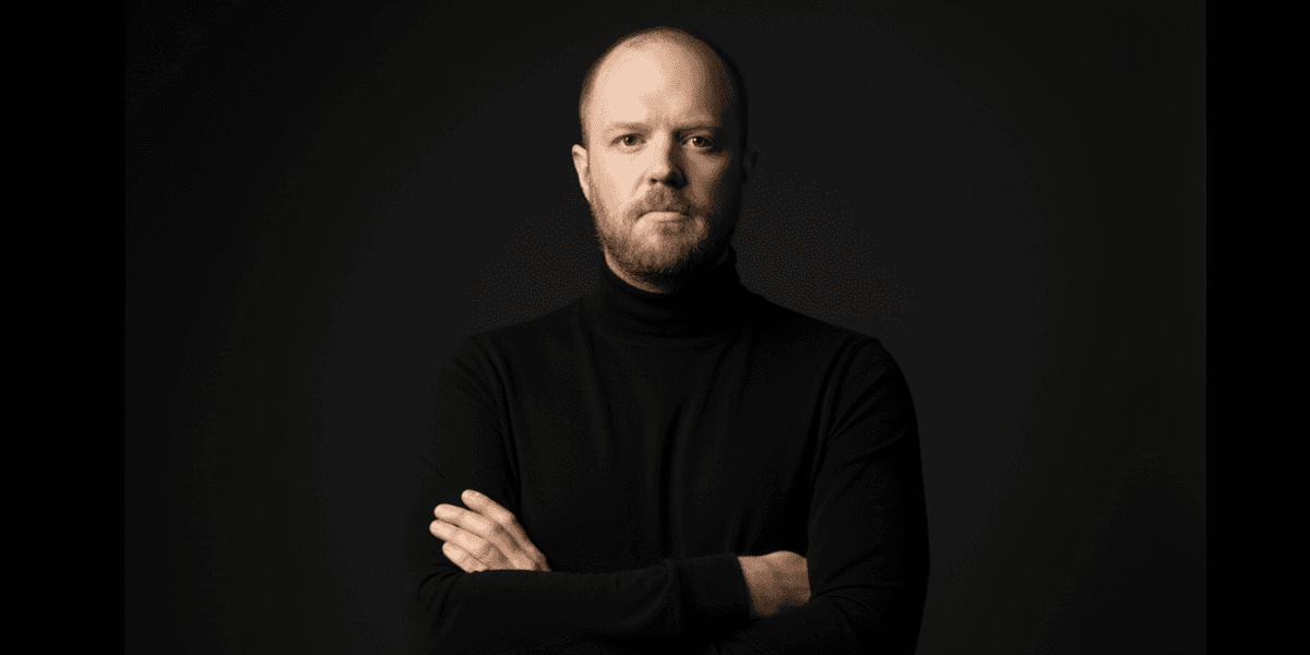Man in black turtleneck poses confidently against dark background, representing North Texas Web Design’s no-nonsense philosophy.